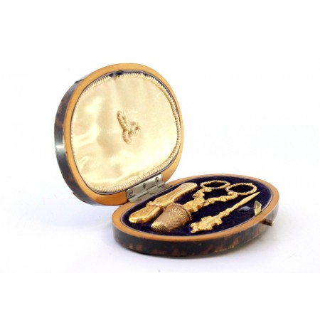 Estojo de costura em ouro com cinco peças, agulha, furador, dedal, agulheiro e tesoura em estojo original de tartaruga.